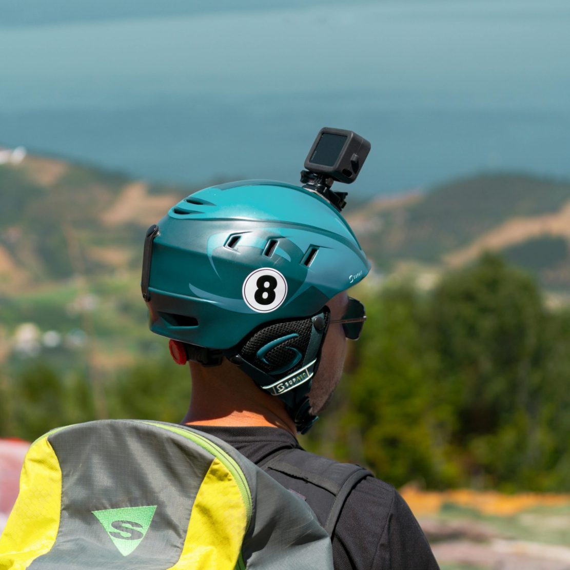 Person with helmet and backpack views vast scenic landscape in Yalova, Türkiye.